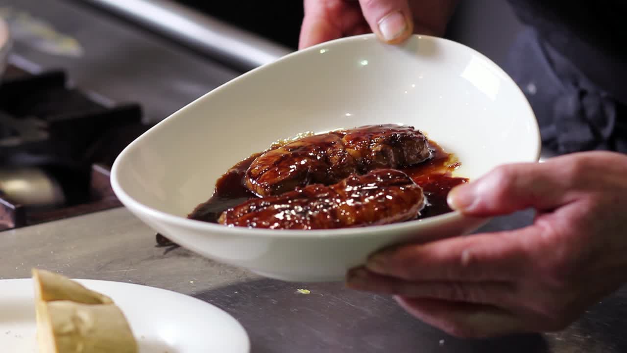 Showing seared foie gras on sherry wine and Pedro Ximenez sauce to camera