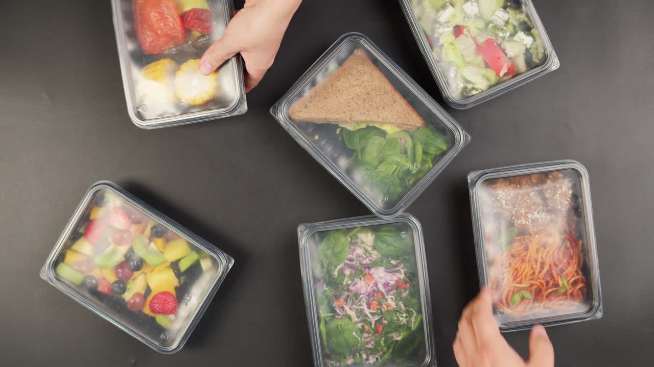 Hands Unpacking Healthy Prepared Meals from Delivery Paper Bags