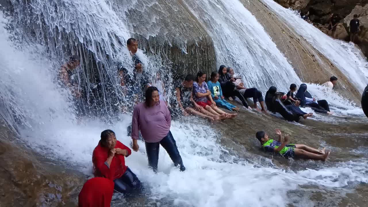 People Enjoying a Waterfall