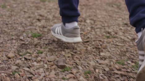 person running on a gravel path