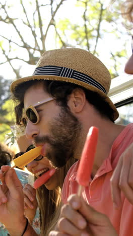 group of hipster friends enjoying and eating ice cream