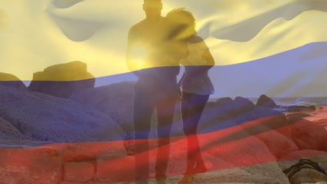 animación de la bandera de colombia sobre una pareja afroamericana en la playa