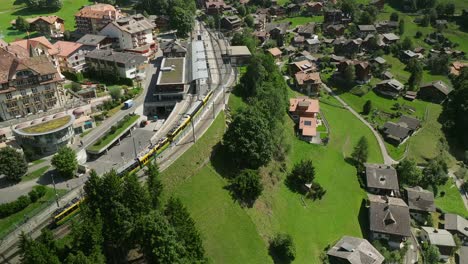 aerial view of the wengenalpbahn ascending to the station in wengen, switzerland 2 of 3