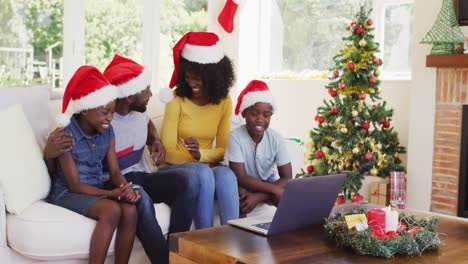 african american family having a videocall on laptop