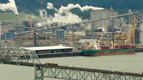 Bridge-over-large-river-port-and-shipping-industry-in-4k-during-the-day-from-a-high-viewpoint