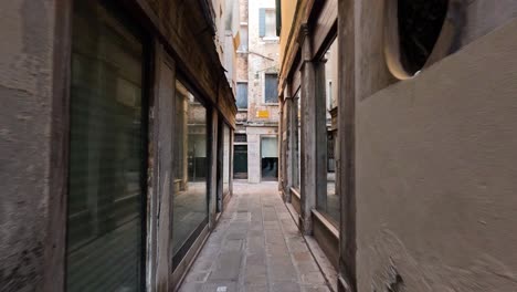 a narrow alleyway in venice, italy