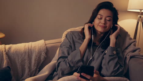woman listening to music at home
