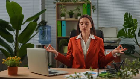businesswoman meditating in the office