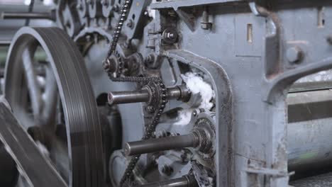 old vintage loom, many rotating wheels