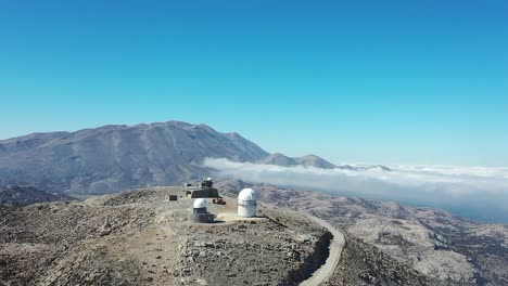 drone captures stunning views of mountain skies and observatory on peak