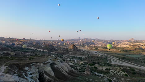 epic aerial cinematic drone shot over cappadocia watching the hot air balloons in the sky in turkey