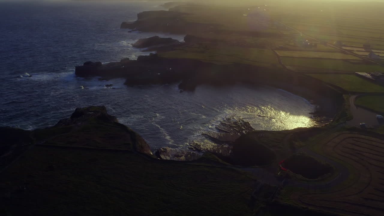 Aerial orbit of the heart-shaped tidal inlet at the Bridges of Ross during sunrise in Kilkee