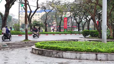 vehicles and scooters navigate a busy hanoi street