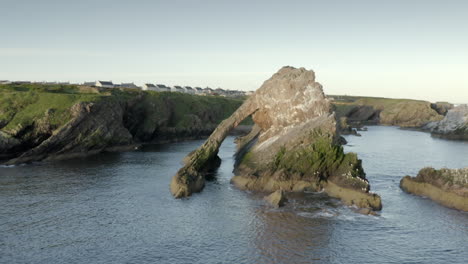 An-aerial-view-of-Bow-Fiddle-Rock-at-Portknockie-on-a-calm-summer's-morning