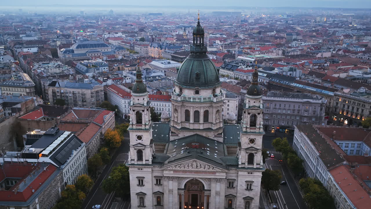 The intricate architecture of St. Stephen’s Basilica shines in the soft morning light above the heart of Budapest