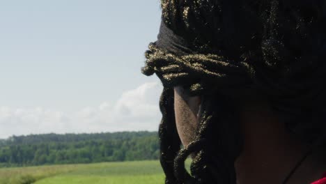 samson with arms raised while looking at surrounding green landscape, biblical character with long dreads, israelite warrior and judge, black male in old testament, christian