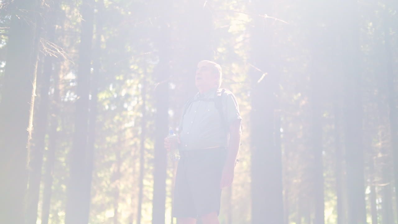Man drinking water in the forest