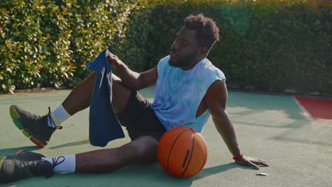 man taking a break from basketball practice