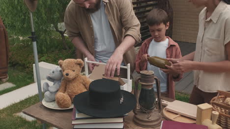 family of three organizing garage sale