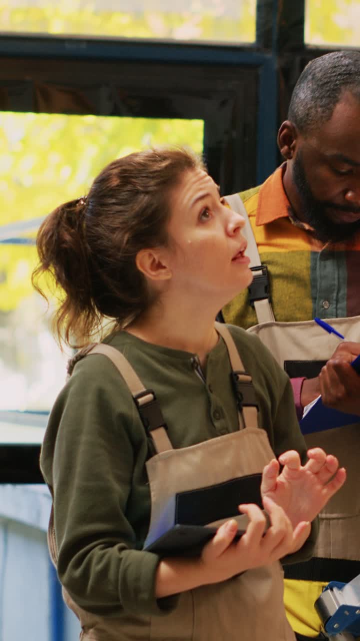 Vertical video: Team of workers verifying stock on racks
