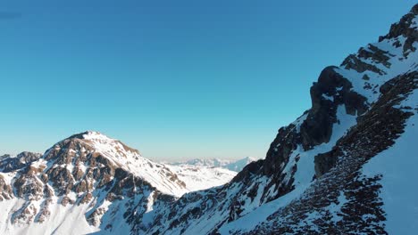 Aerial drone shot of a rocky mountain with snow in the Laograi ridge, Trentino, Italy