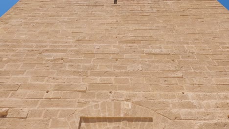 morocco rabbat hassan tower exterior shot of door, tilt up reveals tower top