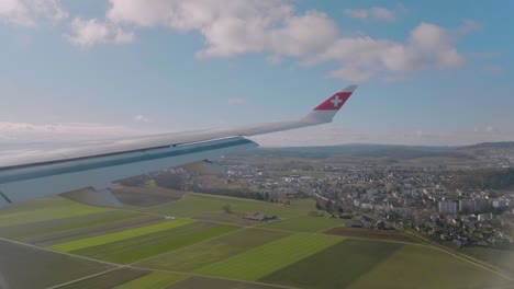 Airplane-window-view,-over-Switzerland