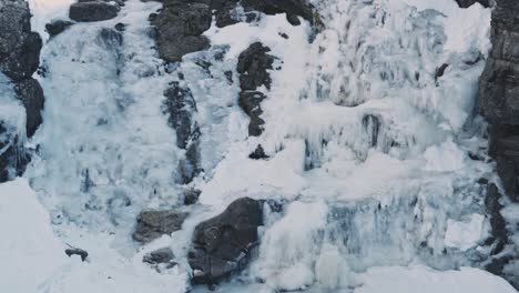 majestic view of frozen waterfall on massive mountain side in norway