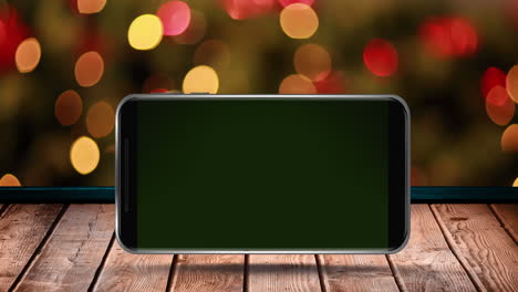animation of blank smartphone screen on wooden surface over flickering fairy lights