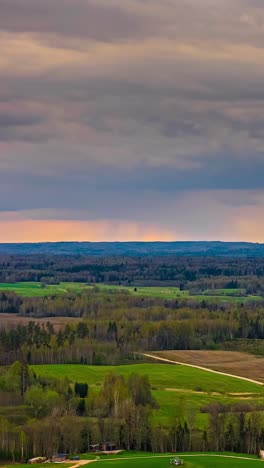 a dark sky slowly slides past over a landscape of meadows and forests