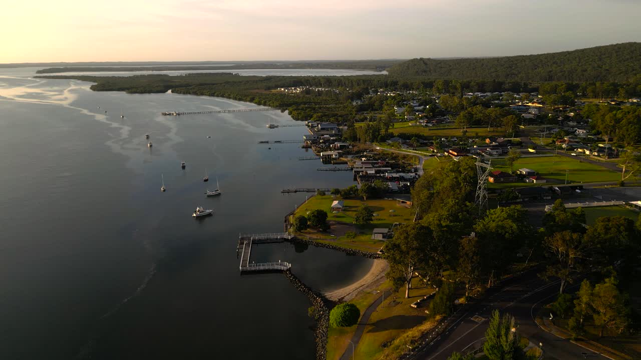 Rising sunrise aerial views of the regional town of Karuah, New South Wales, Australia.