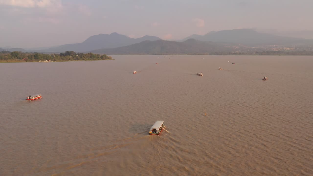 DRONE: TRACKING SHOT OF BOATS AT JANITIZIO IN PATZCUARO LAKE AT THE SUNSET