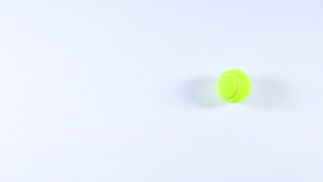 a tennis ball bounces repeatedly on a surface