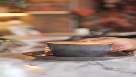 close-up of a cup of coffee on a table in a coffee shop.