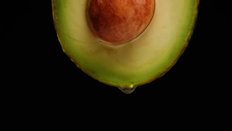 close-up of sliced avocado with dripping oil