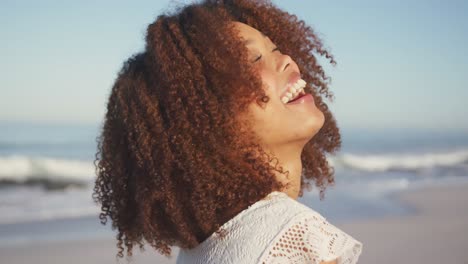 portrait of african american woman laughing at beach