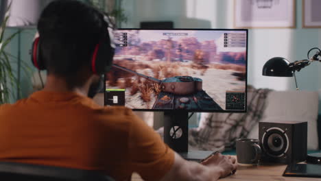 man playing tank game on computer