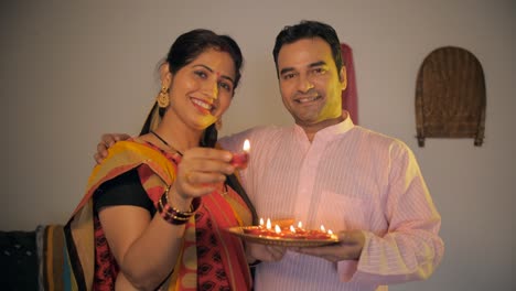 married village couple happily celebrating diwali festival together at home