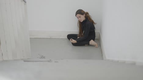 woman sitting in a corner
