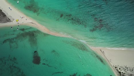 A-sandy-strip-surrounded-by-clear-turquoise-water-in-los-roques,-aerial-view