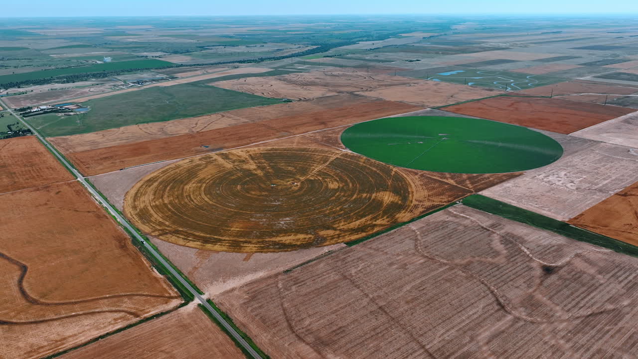 Vast agricultural plantations with two circles in the middle. Aerial perspective on the center pivot irrigation.