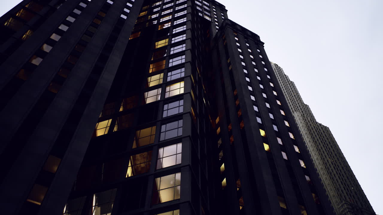 City skyscrapers reflect evening light in urban atmosphere