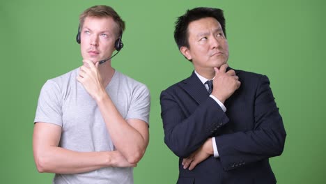 mature japanese businessman and young scandinavian man worker together