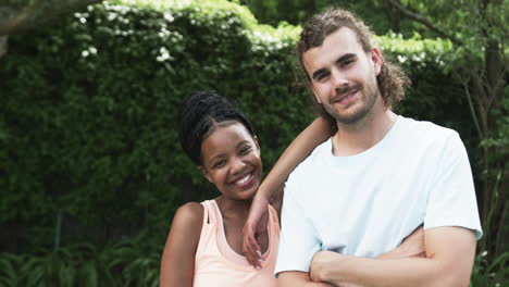 Diverse-couple-enjoys-a-sunny-day-outdoors,-with-copy-space