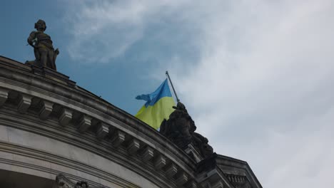 ukrainian flag waving over a monument