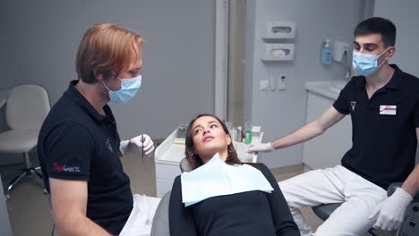 professional stomatologist at work. dentist treating teeth to woman patient in clinic