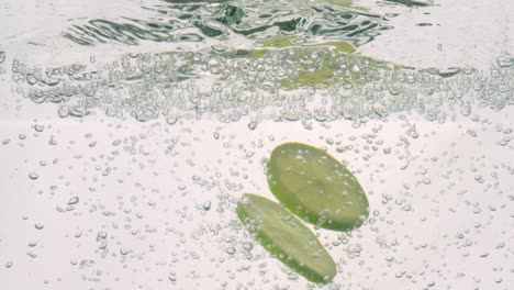 lime slices falling deeply under water. shot on super slow motion camera 1000 fps