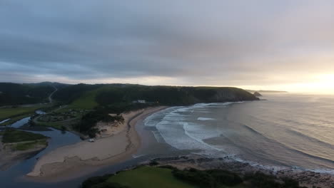 cinematic aerial flying at sunrise over east london south africa coast