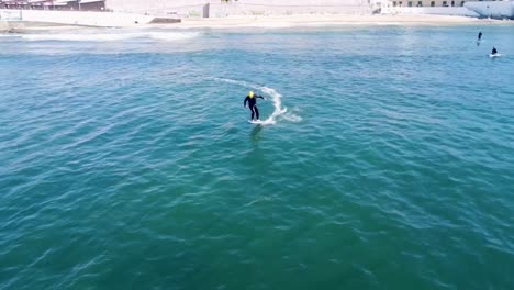 man riding an efoil on the ocean