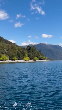 lago lacar quila quina in argentina, clear blue water surrounded by lush green mountains